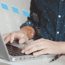 Person typing at laptop